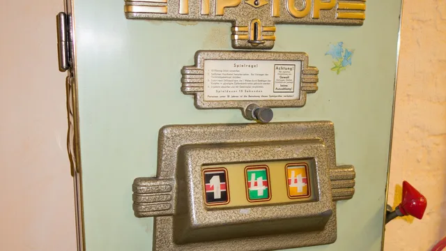 Antique Tip Top slot machine with three reels mounted on a wall