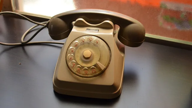 A rotary desk telephone on a table